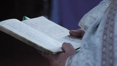 Bible is in the hands of the priest. Rite in the temple Stock Footage 99765786