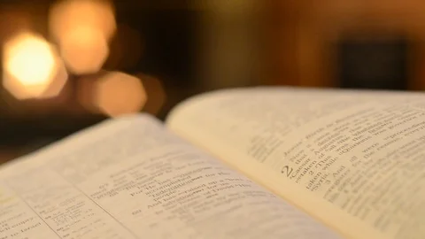 Bible open to Luke with page turning Video stock 107537020