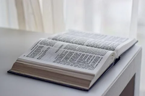 Bible sitting next to the window Stock Photos