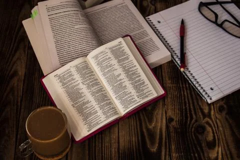Bible study stack of books notepad glasses Stock Photos
