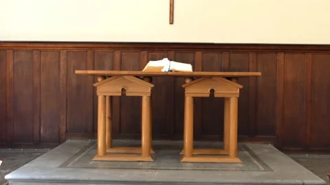 The Bible is on the table and crosses on the wall inside the church. Stock Footage 86415279