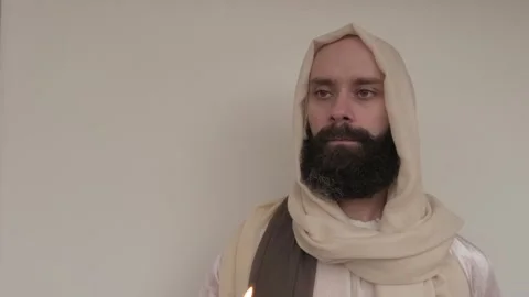 Biblical scene, Jesus Christ Hand holds burning candle, young bearded and m.. Stock Footage 252192984