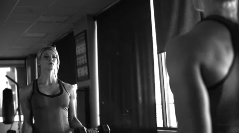 Bicep curl in mirror black and white with film grain Video stock 33689682