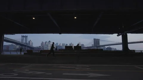 Bicycle and runners under bridge at south street seaport Stock Footage 150588199