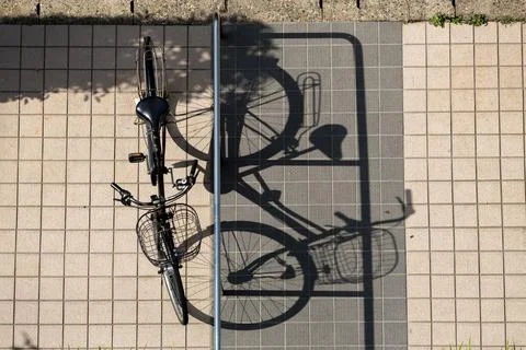 Bicycle and Shadow on Tiled Surface Captured from an Overhead Perspective 스톡 사진