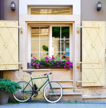A bicycle on the background of an old window Stock Photos