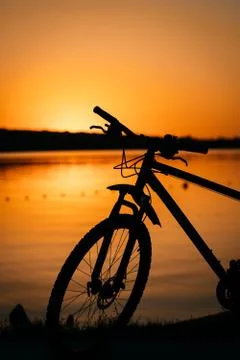 Bicycle on the background of a sunset Stock Photos