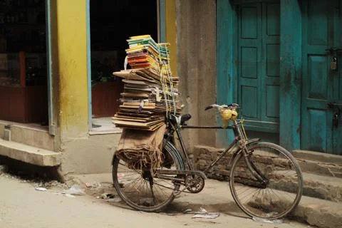 Bicycle balancing stack of cardboard Stock Photos