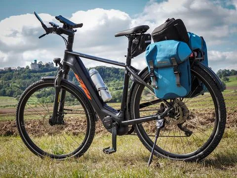 A bicycle with a blue bag on the back Stock Photos