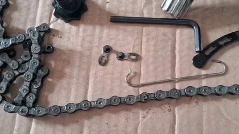 Bicycle chain repair components laying on cardboard video motion footage Stock Footage 339091108