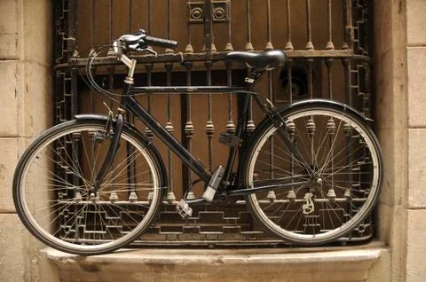 Bicycle chained to window Stock Photos