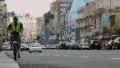 Bicycle on city street, traffic at daytime, cars passing by HD Footage