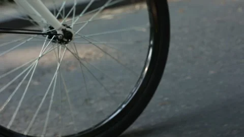 Bicycle close up front wheel and pan left to back wheel Stock Footage 147910043