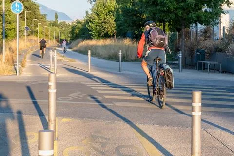 Bicycle commuter entering a protected shared path Stock Photos