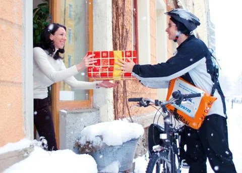 A bicycle courier delivers a parcel Stock Photos