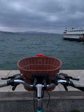 Bicycle facing the sea on a waterfront Stock Photos