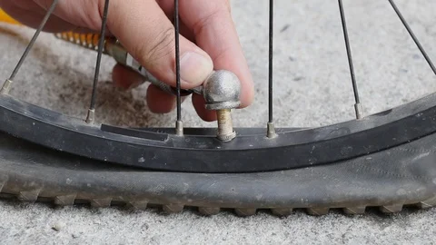 Bicycle flat tyre successfully inflated on concrete floor Stockbeeldmateriaal 107828517