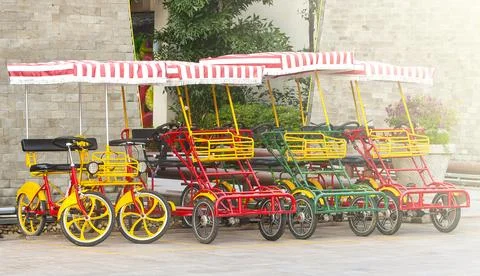 Bicycle with four wheels on the square on soft sunlight Stock Photos