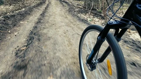 Bicycle front wheel &amp; fork POV on forest dirt road. Bike riding footage Stock Footage 305161055