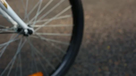 Bicycle front wheel roll close up Stock Footage 147910033