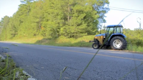 Bicycle going past tractor Slow Motion 스톡 동영상 103643444