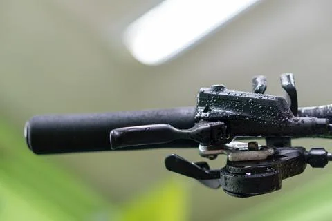Bicycle handlebar close-up in the workshop against the background of a lamp.  Stock Photos