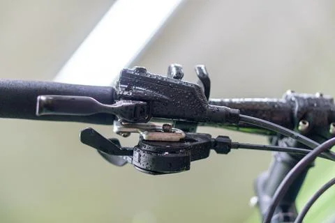 Bicycle handlebar close-up in the workshop against the background of a lamp.  Stock Photos