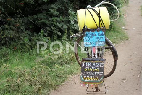 Bicycle with important message (Money Can Not Buy Happiness) in Kenya, Africa. Stock Photos