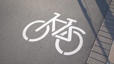 Bicycle lane sign with a passing man Stock Footage