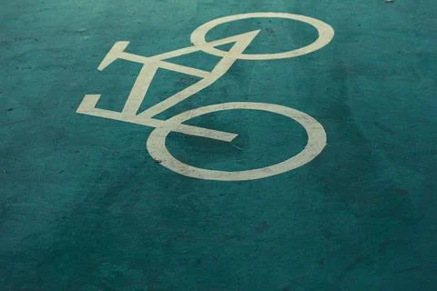 Bicycle lane sign in yellow with solid lines on asphalt road in Indonesia. Stock Photos