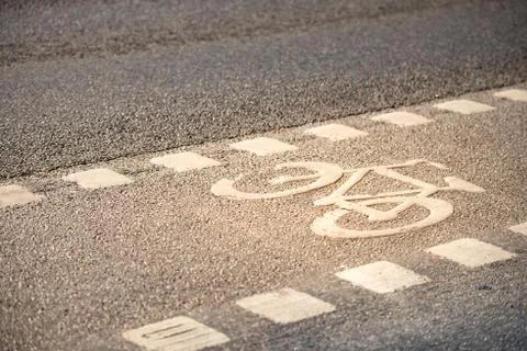 Bicycle lane symbol on the ground. Stock Photos