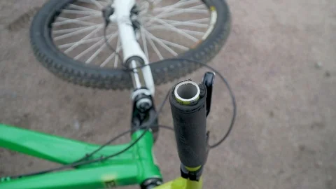 The bicycle lies on the ground, in the foreground frame the steering wheel Stock Footage 116489325