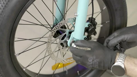 Bicycle Maintenance Assembling E-bike Front Wheel Stock Footage 296347129