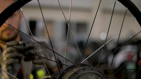 A bicycle master repairs and balances a bicycle wheel. Bicycle service. Stock Footage 302244475