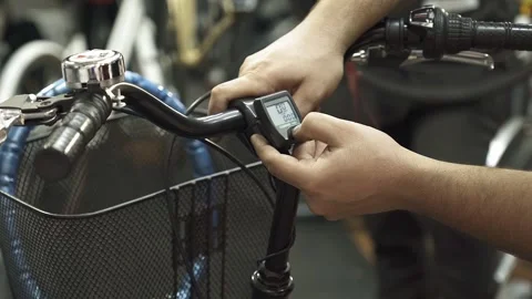 A bicycle mechanic explaining the functionality of a bicycle odometer. Stock Footage 243271656