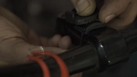 A bicycle mechanic installing a bracket for a bicycle odometer. Stock Footage 243272462