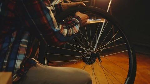 Bicycle mechanic work process in low key cinematic light Stock Footage 85400149
