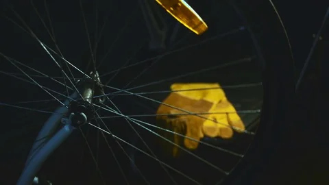 Bicycle mechanic work process in low key cinematic light Stock Footage 85400255
