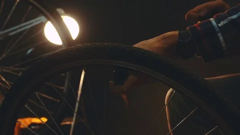 Bicycle mechanic work process in low key cinematic light Stock Footage 85400418