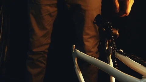 Bicycle mechanic work process in low key cinematic light Stock Footage 85400514