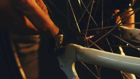 Bicycle mechanic work process in low key cinematic light Stock-Footage 85400534