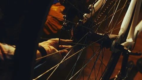 Bicycle mechanic work process in low key cinematic light Stock-Footage 85400624