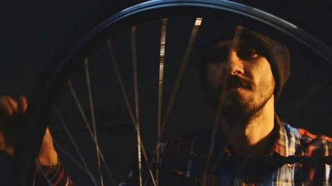 Bicycle mechanic work process in low key cinematic light Stock Footage 85400844