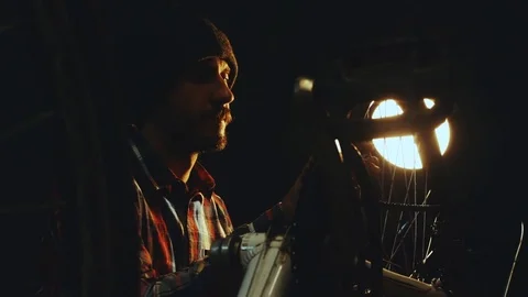 Bicycle mechanic work process in low key cinematic light Stock Footage 85400922