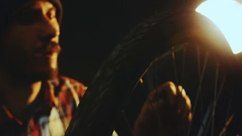 Bicycle mechanic work process in low key cinematic light Stock Footage 85400970