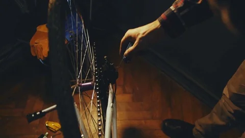 Bicycle mechanic work process in low key cinematic light Stock Footage 85401061
