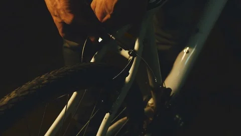 Bicycle mechanic work process in low key cinematic light Stock Footage 85401191