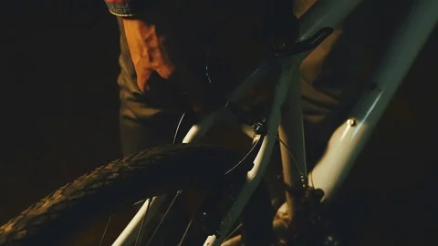 Bicycle mechanic work process in low key cinematic light Stock Footage 85401207