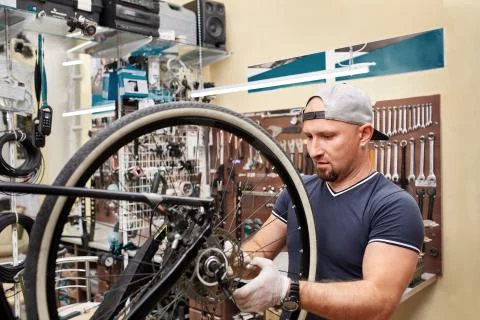 Bicycle mechanic in a workshop in the repair process Stock Photos