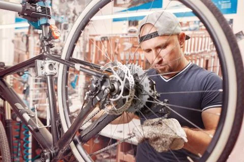Bicycle mechanic in a workshop in the repair process Stock Photos